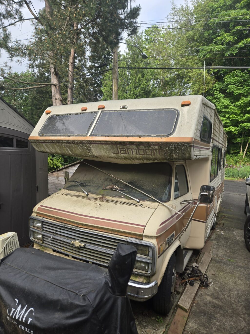Drivable Jamboree camper parked on grass ready for eco-friendly recycling and removal service.